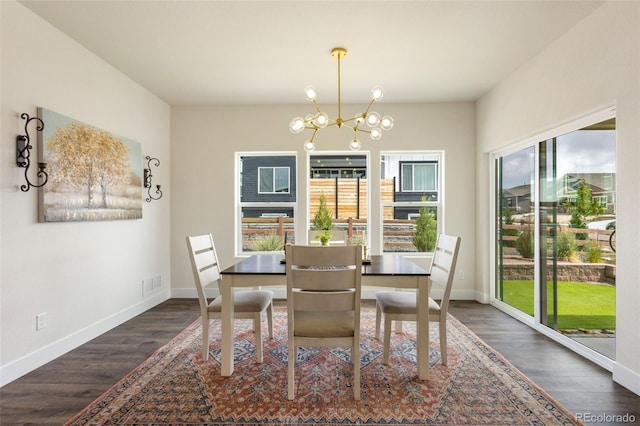 dining room with dark hardwood / wood-style floors and an inviting chandelier