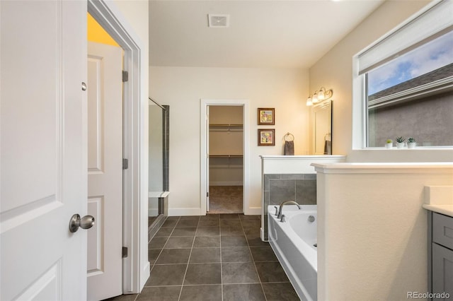 bathroom with shower with separate bathtub, tile flooring, and oversized vanity