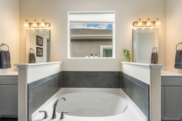 bathroom with vanity and a tub