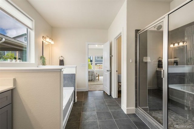 full bathroom featuring tile floors, independent shower and bath, vanity, and toilet