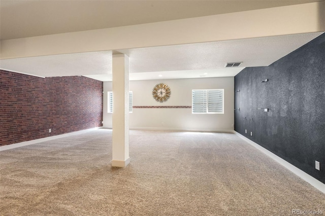 basement with a textured ceiling and carpet floors