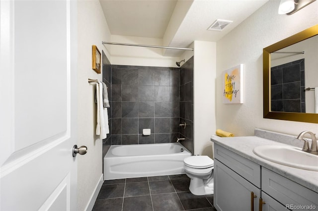 full bathroom with tiled shower / bath, vanity, toilet, and tile floors