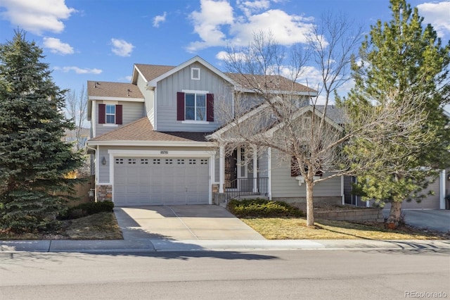 traditional home with roof with shingles, board and batten siding, and driveway