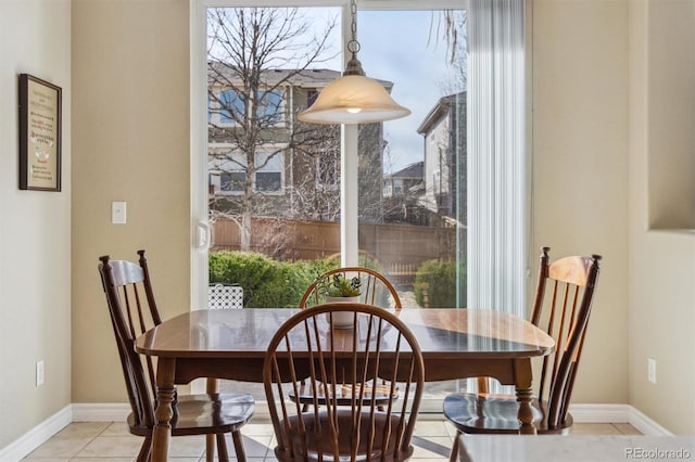 dining space with light tile patterned floors and baseboards