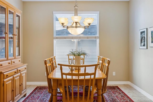 dining space featuring baseboards, a notable chandelier, and light tile patterned flooring