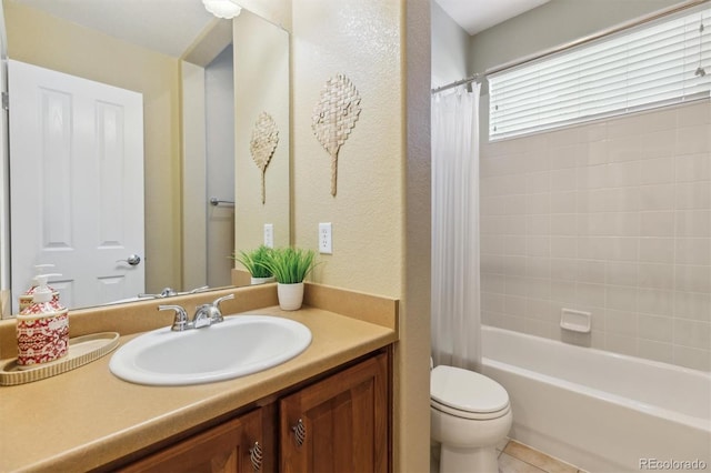 bathroom with vanity, tile patterned floors, toilet, a textured wall, and shower / tub combo with curtain