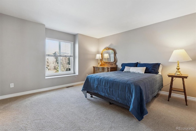 bedroom with visible vents, carpet, and baseboards