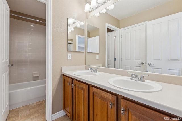 full bathroom featuring double vanity, shower / bathtub combination, and a sink