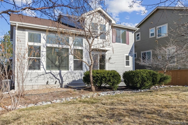 exterior space featuring a front lawn and fence