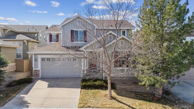 view of front of home featuring stone siding, an attached garage, driveway, and a shingled roof