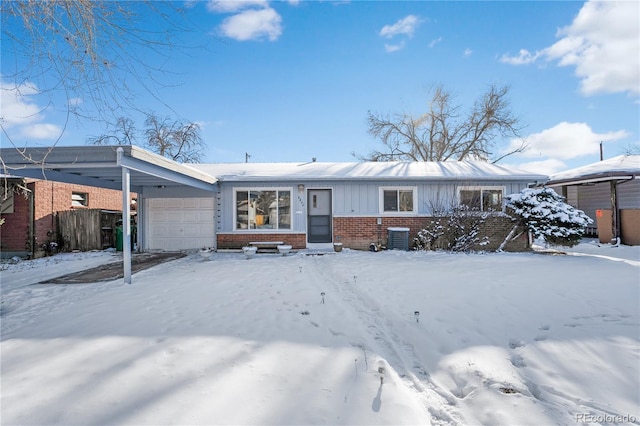 view of front of home with central air condition unit, a carport, and a garage