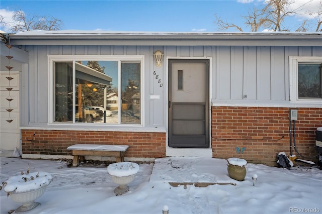 view of snow covered property entrance