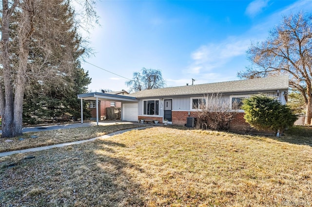 ranch-style house with brick siding, an attached garage, a front yard, central AC unit, and driveway