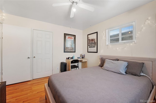 bedroom with a ceiling fan and light wood-type flooring