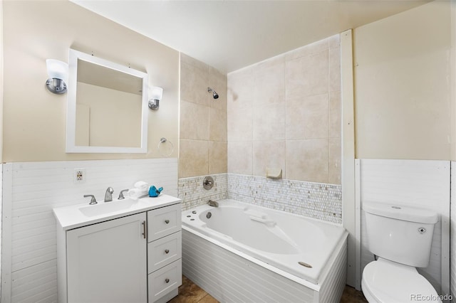 full bath featuring wainscoting, toilet, shower / washtub combination, and vanity