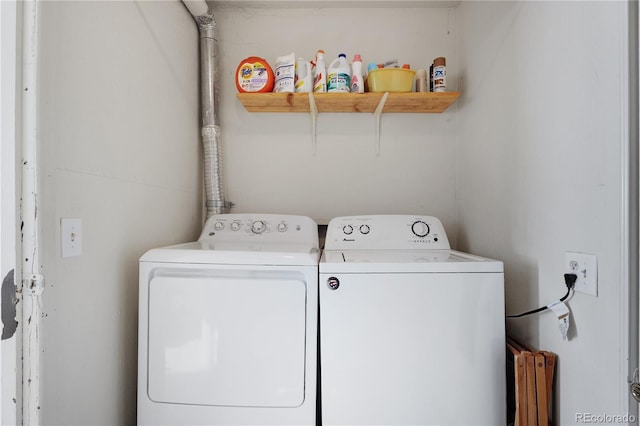 clothes washing area featuring laundry area and washing machine and clothes dryer