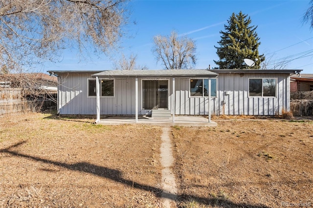 single story home with board and batten siding and fence