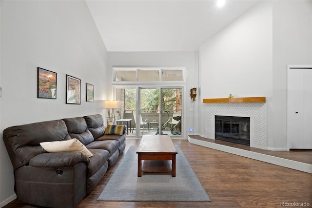 23551 Genesee Village Rd Unit H, Golden, CO 80401 - living room featuring high vaulted ceiling, wood finished floors, a fireplace, and baseboards