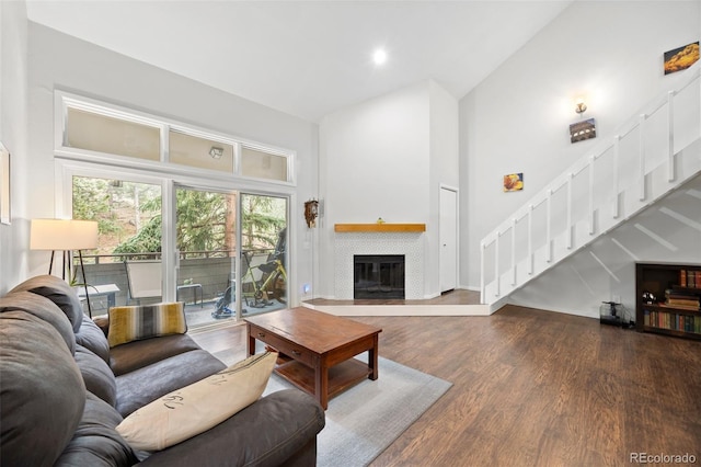 23551 Genesee Village Rd Unit H, Golden, CO 80401 - living area featuring stairs, high vaulted ceiling, wood finished floors, a glass covered fireplace, and recessed lighting