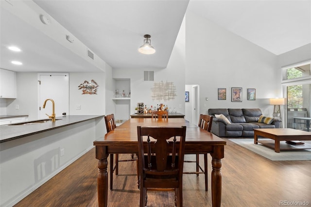 23551 Genesee Village Rd Unit H, Golden, CO 80401 - dining room featuring dark wood finished floors and high vaulted ceiling