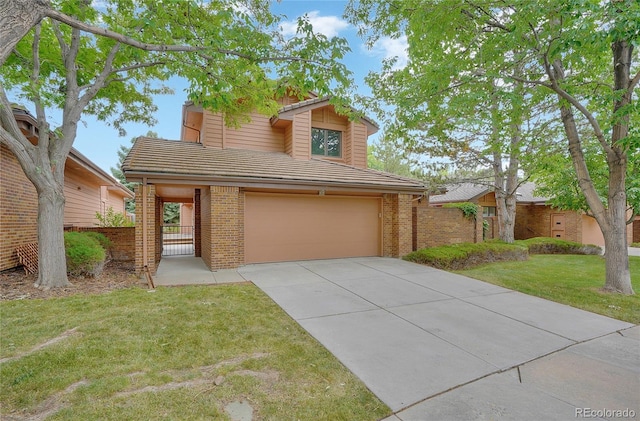 view of front of property featuring a garage and a front lawn