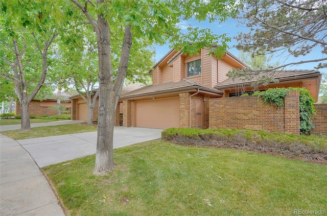 view of property with a garage and a front yard