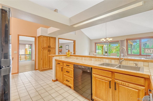 kitchen with tile counters, decorative light fixtures, black dishwasher, sink, and vaulted ceiling