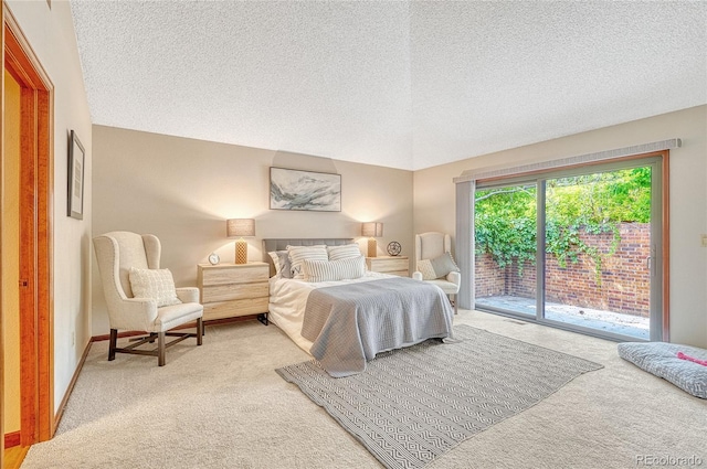 bedroom featuring access to outside, light colored carpet, and a textured ceiling