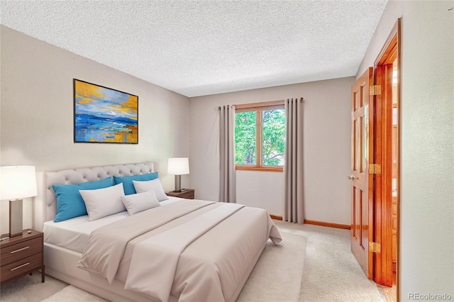 bedroom featuring light colored carpet and a textured ceiling