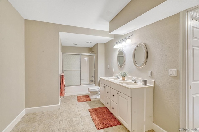 full bathroom featuring tile patterned floors, bath / shower combo with glass door, toilet, and vanity