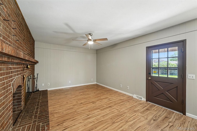 1354 S Macon St, Aurora, CO 80012 - unfurnished living room featuring a fireplace, wood finished floors, a ceiling fan, and baseboards