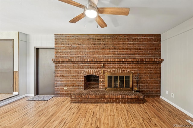 1354 S Macon St, Aurora, CO 80012 - unfurnished living room featuring wood finished floors, a ceiling fan, a fireplace, and baseboards
