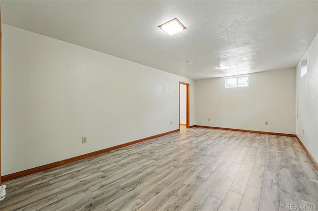 1354 S Macon St, Aurora, CO 80012 - unfurnished room with light wood-style flooring, baseboards, and a textured ceiling