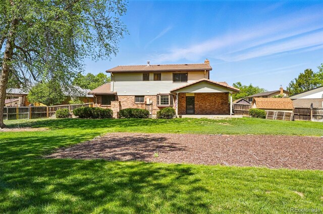 1354 S Macon St, Aurora, CO 80012 - rear view of property with a chimney and brick siding