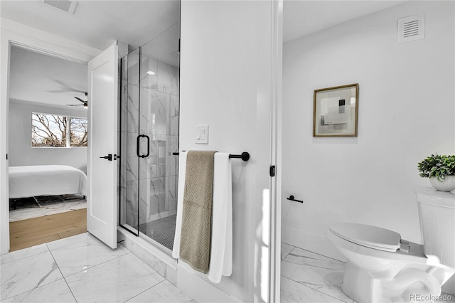 full bathroom featuring toilet, connected bathroom, marble finish floors, a marble finish shower, and a ceiling fan