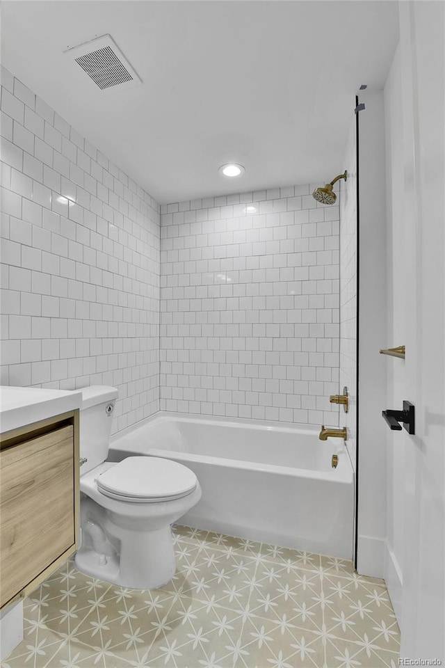 full bath featuring tub / shower combination, toilet, tile walls, vanity, and tile patterned floors