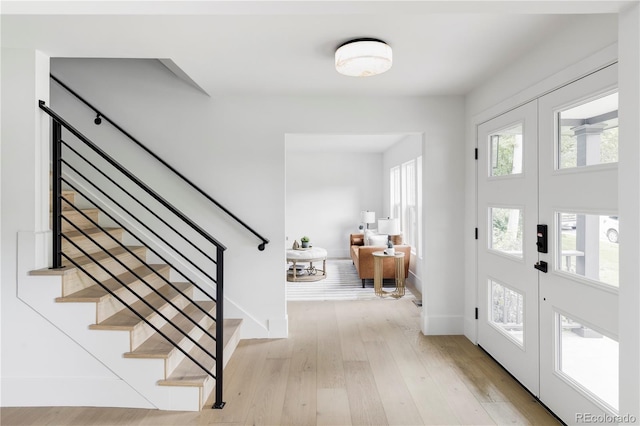 3930 S Hillcrest Dr, Denver, CO 80237 - entrance foyer with light wood-style floors, stairs, and baseboards