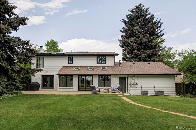 3930 S Hillcrest Dr, Denver, CO 80237 - back of property featuring french doors, a patio area, solar panels, a chimney, and central AC unit
