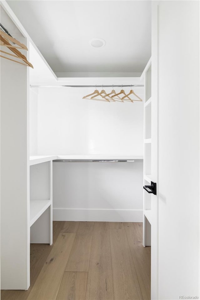 3930 S Hillcrest Dr, Denver, CO 80237 - walk in closet featuring wood finished floors