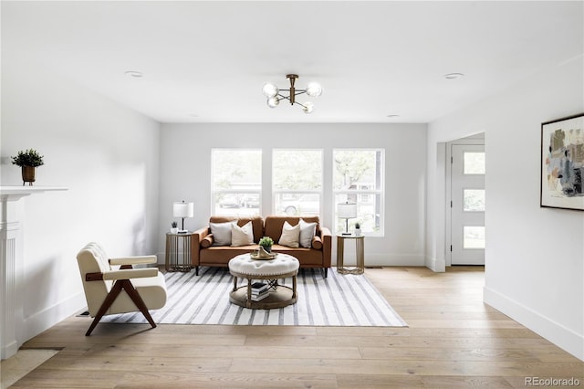 3930 S Hillcrest Dr, Denver, CO 80237 - living room featuring healthy amount of natural light, light wood-style floors, and a chandelier
