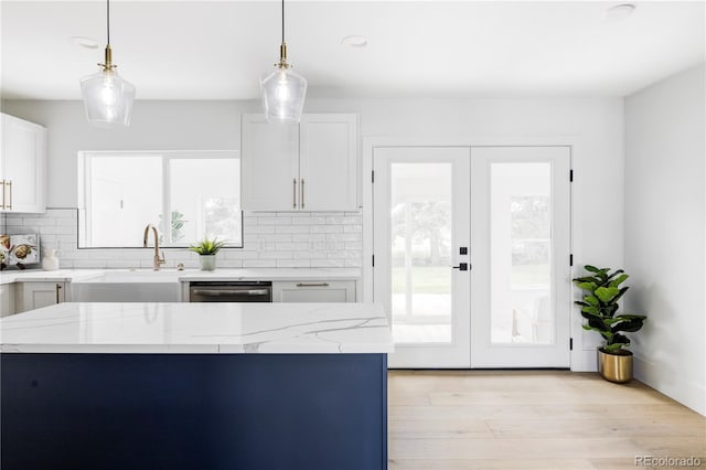 3930 S Hillcrest Dr, Denver, CO 80237 - kitchen with french doors, dishwasher, decorative backsplash, light stone countertops, and white cabinetry