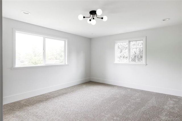 3930 S Hillcrest Dr, Denver, CO 80237 - carpeted spare room featuring plenty of natural light and a chandelier