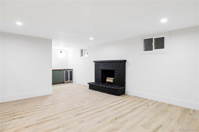 3930 S Hillcrest Dr, Denver, CO 80237 - unfurnished living room with wood finished floors, recessed lighting, a brick fireplace, and beverage cooler