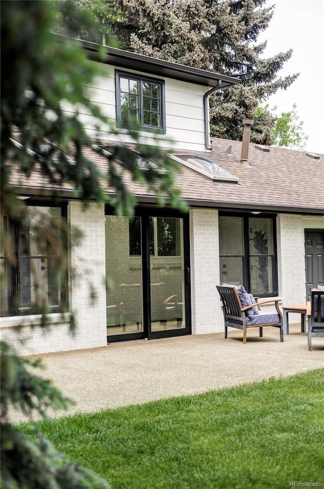 3930 S Hillcrest Dr, Denver, CO 80237 - back of house featuring brick siding and a shingled roof