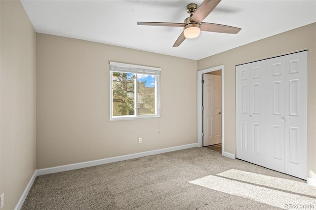 unfurnished bedroom with ceiling fan, a closet, and light colored carpet