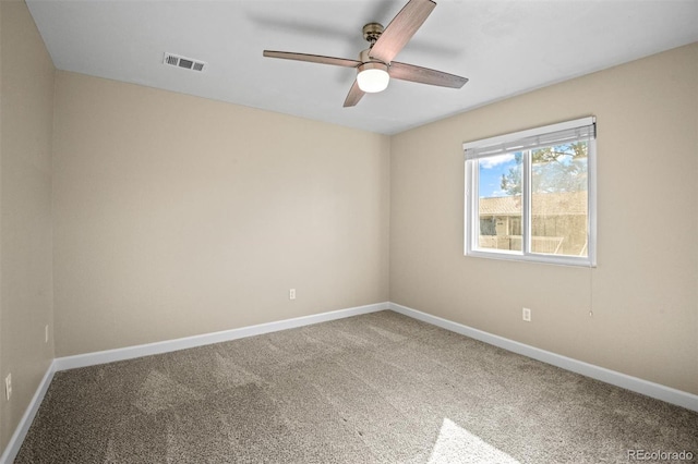 carpeted spare room featuring ceiling fan