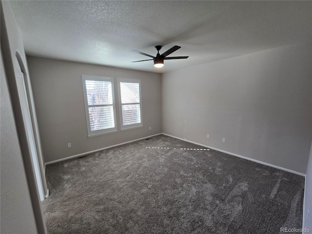 carpeted spare room featuring a ceiling fan, a textured ceiling, and baseboards