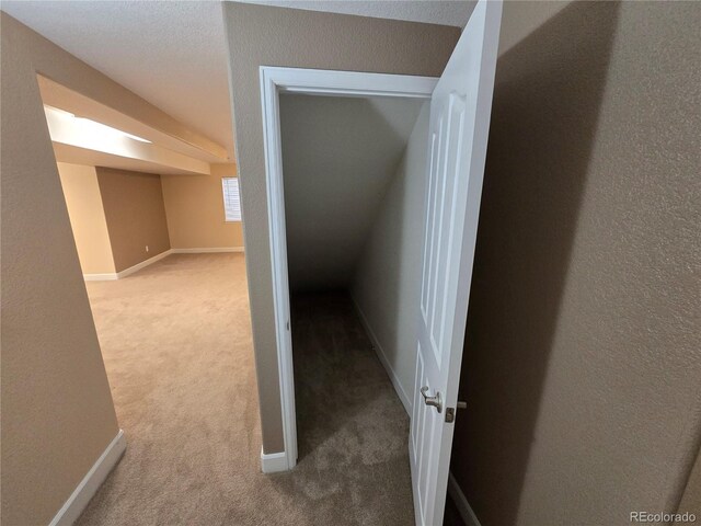 hall with carpet floors and baseboards