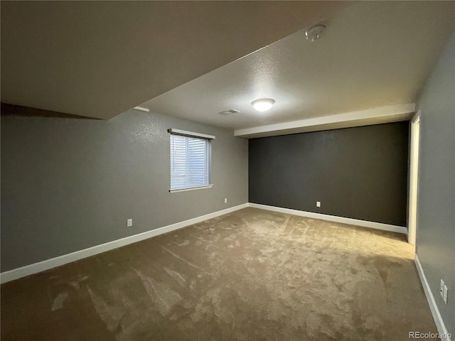 basement featuring carpet flooring and baseboards