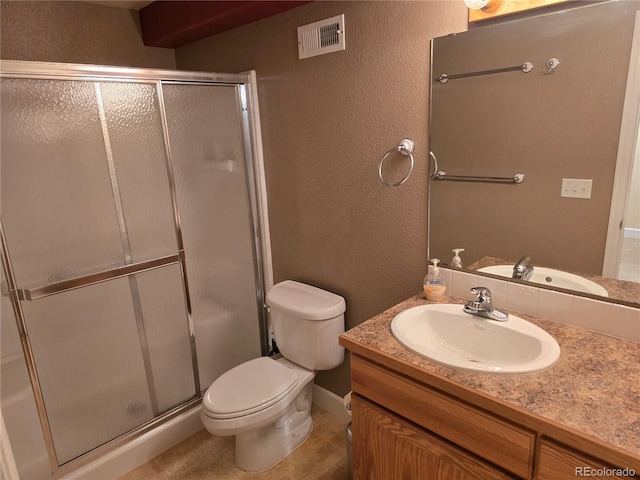 bathroom featuring toilet, a stall shower, visible vents, and vanity